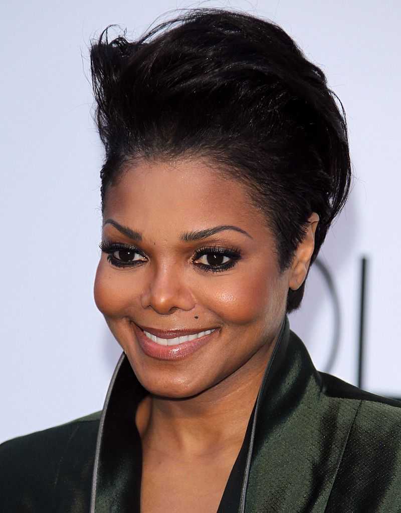 Janet Jackson who is smiling and looking at the camera
