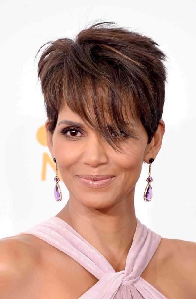 Halle Berry wearing a purple shirt and smiling at the camera